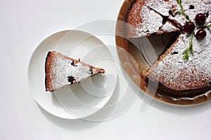 Pice of freshly baked cherry cake on white table background. Overhead view of homemade berry pie.