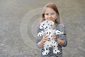 Pick the best. Happy girl play with toy dog outdoors. Toy shop. Games and activities. Child development. Preschool