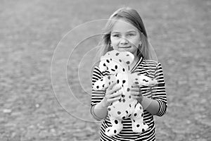 Pick the best. Happy girl play with toy dog outdoors. Toy shop. Games and activities. Child development. Preschool