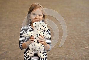 Pick the best. Happy girl play with toy dog outdoors. Toy shop. Games and activities. Child development. Preschool