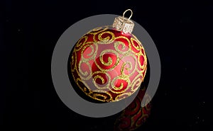 Pick decor for christmas tree. Christmas ornament single red ball on black background. Christmas ornament concept
