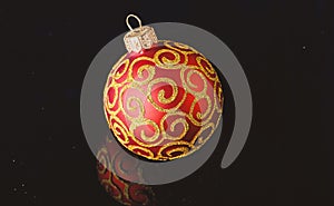 Pick decor for christmas tree. Christmas ornament single red ball on black background. Christmas ornament concept