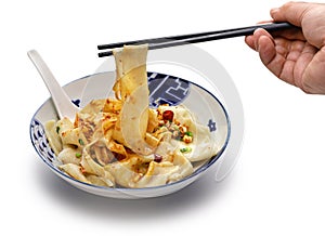 Pick up Biangbiang noodles with chopsticks, Chinese Shaanxi cuisine