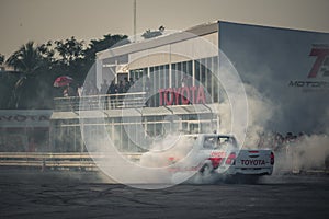 Pick-up car perform burnout tire on the track