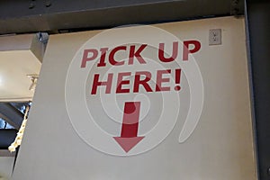 Pick up here sign at a restaurant