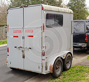 Horse trailer parked on neighborhood street