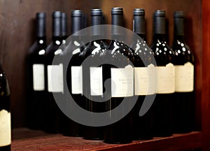 Pick your favorite. Shot of some bottles of wine on a shelf in a wine cellar.