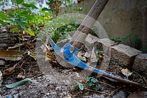 A pickaxe, or pick is a generally T-shaped hand tool used for prying. Garden tools in an organic Indian farmland, traditional