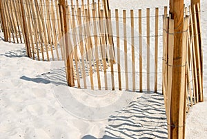 Picket fence on white sand beach. photo