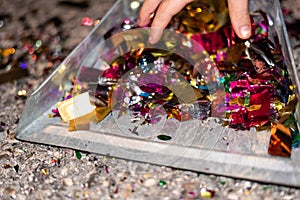 Picking up and cleaning the confetti remains of a party