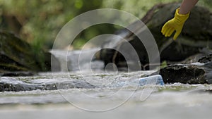 Picking up garbage water plastic nature. Volunteer cleaning river trash pick up litter picking. Cleaning trash mountain