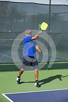 Pickleball Action - Man in Blue Following Through After Serving the Ball