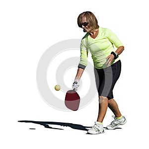 Pickleball Action - Senior Woman Serving Ball photo