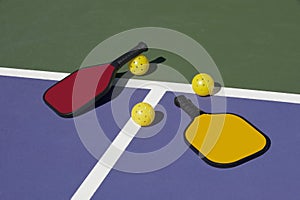 Pickleball - colorful paddles, ball and court photo