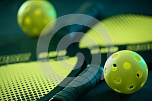 Pickleball game set. Rackets and balls on the court. Copy space. Sports background.