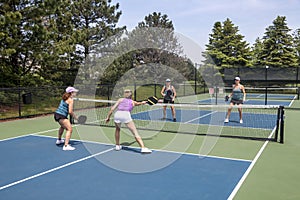 Pickleball Players in Action at Net