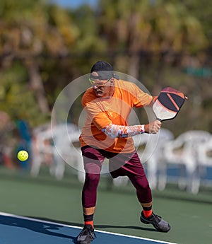 Pickleball pro prepares to slice ball using a backhand