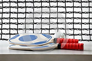 Pickleball rackets and balls on white table and background network