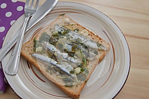 Pickled anchovies on sliced bread served as an appetizer in a bar