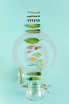 Pickled cucumbers. Ingredients for marinated gherkins and glass jar on blue background. Concept culinary recipe preservation of