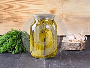 Pickled cucumbers on wooden background