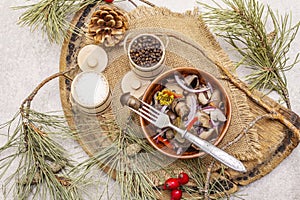 Pickled or fermented mushrooms. Traditional Christmas snack. New Year Festive cutlery
