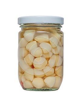 Pickled garlic in a glass jar.