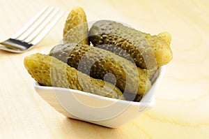 Pickled gherkins in a small bowl