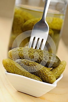 Pickled gherkins in a small bowl