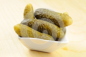 Pickled gherkins in a small bowl