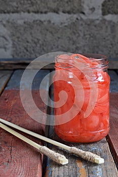 Pickled ginger slices and wooden chopsticks. Ingredient for sushi. Healthy food. Traditional Japanese condiment.