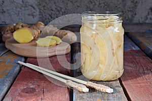 Pickled ginger slices and wooden chopsticks. Ingredient for sushi. Healthy food. Traditional Japanese condiment.