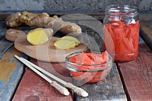 Pickled ginger slices and wooden chopsticks. Ingredient for sushi. Healthy food. Traditional Japanese condiment.