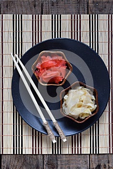 Pickled ginger slices and wooden chopsticks. Ingredient for sushi. Healthy food. Traditional Japanese condiment.