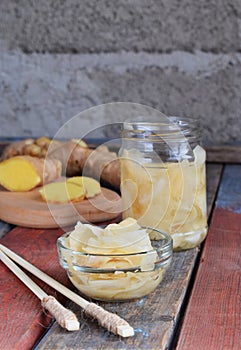 Pickled ginger slices and wooden chopsticks. Ingredient for sushi. Healthy food. Traditional Japanese condiment