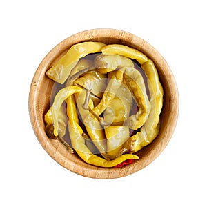 Pickled green hot chili peppers in wooden bowl isolated on white background