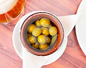 Pickled green olives with cucumber - typical Spanish tapas olivas verdes y pepinos