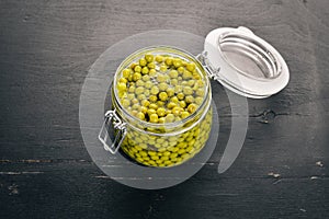 Pickled green peas in a jar. Stocks of food.