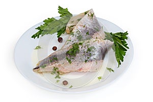 Pickled herring fillets sprinkled with chopped dill, parsley on dish