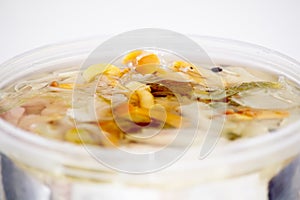 Pickled herring in a jar closeup