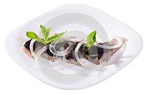 Pickled herring with onions and mint leaves