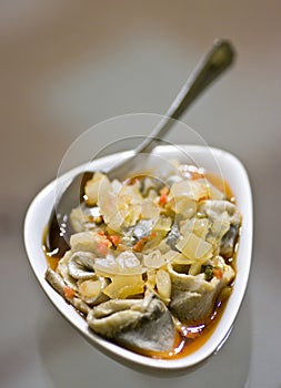 Pickled herring rolls in bowl