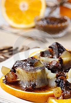 Pickled herring rolls with dried fruits and plum sauce