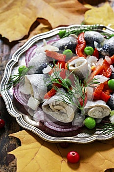 Pickled herring rolls with vegetables