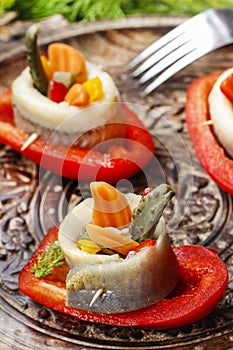 Pickled herring rolls with vegetables