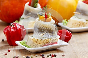 Pickled herring rolls with vegetables