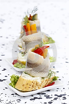 Pickled herring rolls with vegetables