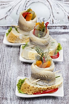 Pickled herring rolls with vegetables