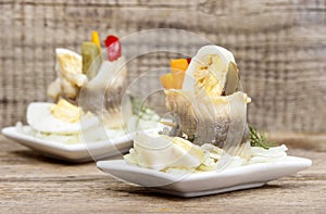 Pickled herring rolls with vegetables