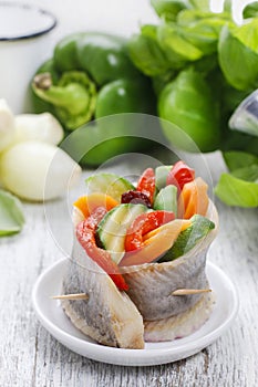 Pickled herring rolls with vegetables